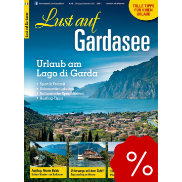 Berglandschaft mit See, Boot und Holzsteg, Titel 'Lust auf Südtirol', Text zu Genussregion und Ausflugstipps, rotes Prozentzeichen unten rechts.