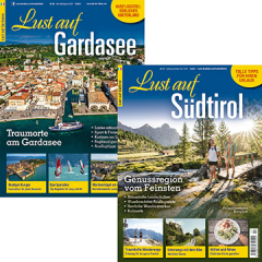 Zwei Reisemagazine: 'Lust auf Gardasee' mit Luftaufnahme einer Stadt und 'Lust auf S&uuml;dtirol' mit Wanderern auf Bergweg vor Bergen.